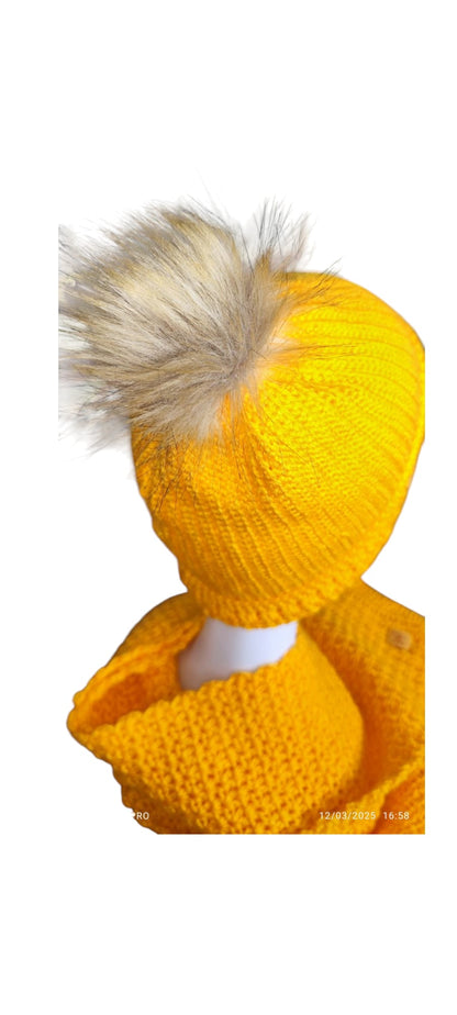Close-up of the Golden Sun set’s crochet texture and faux-fur pom-pom on the bright yellow beanie.