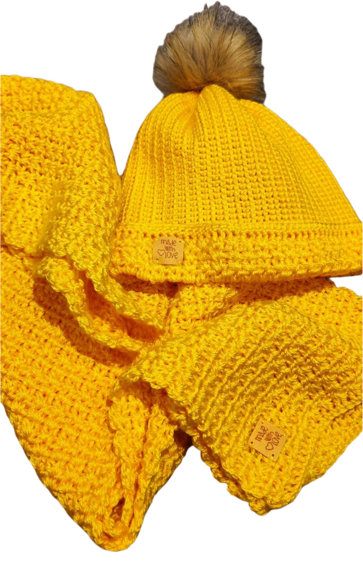  Flat lay of the Golden Sun crochet winter set showing the beanie with pom-pom and matching thick scarf.