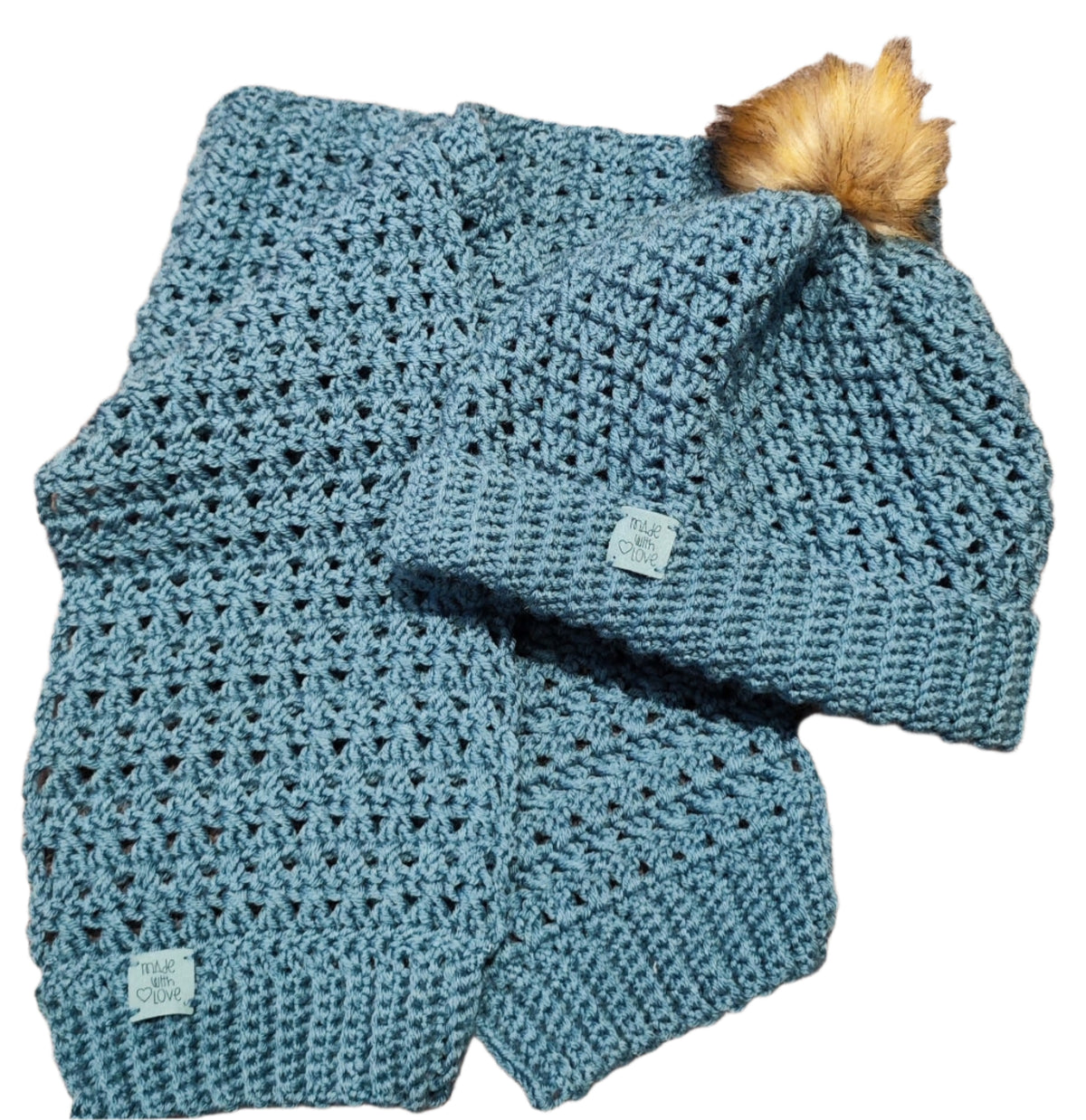 Flat lay of the Sky Blue crochet set showing the detailed texture of the scarf and ribbed stitch beanie with pom-pom.