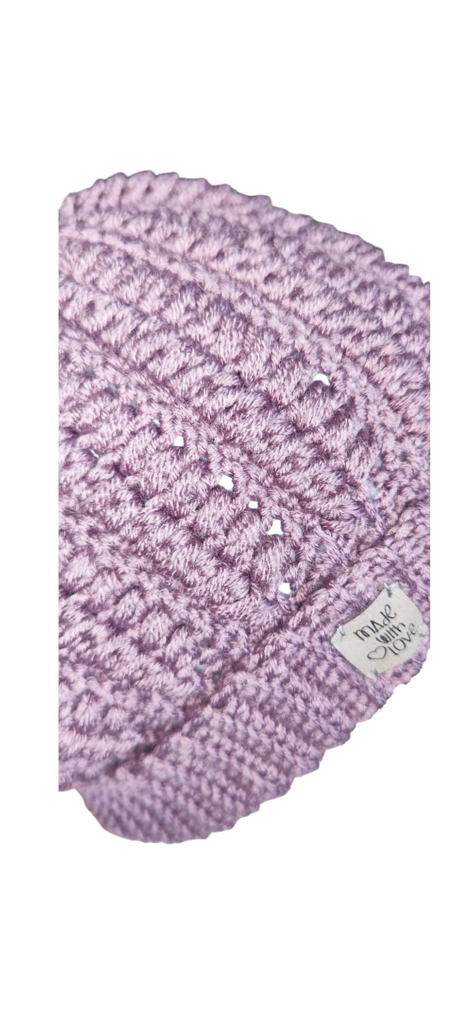 Close-up of the Soft Lavender Beanie’s faux-fur pom-pom and stitch detail with signature brand tag.